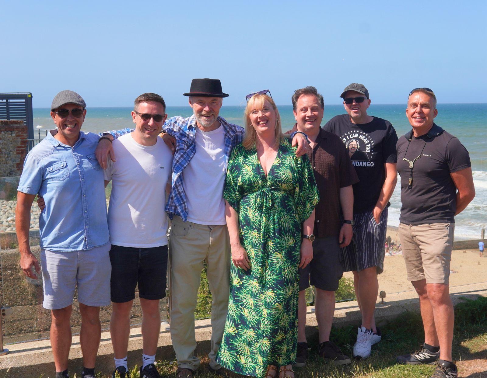 The seven members of the Soul Setters on the seafront in Norfolk on a sunny day
