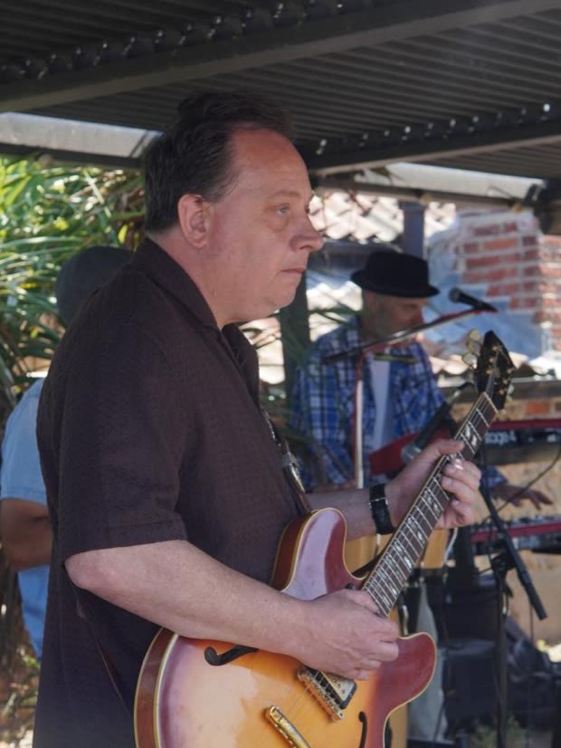 Luke Cross playing a semi-hollow electric guitar